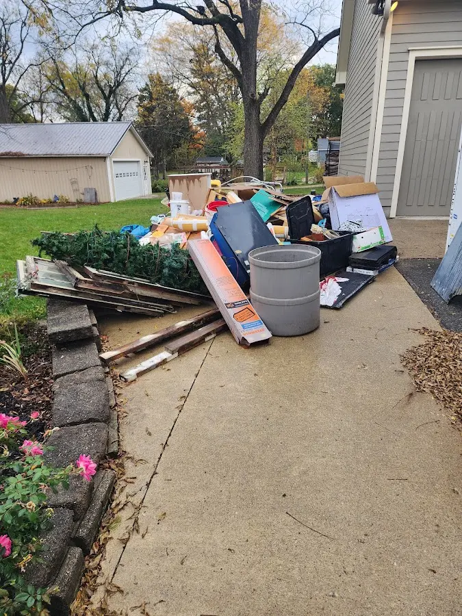 Dumpster being loaded with debris for Estate Cleanout Dumpster Rental in Rockville Centre